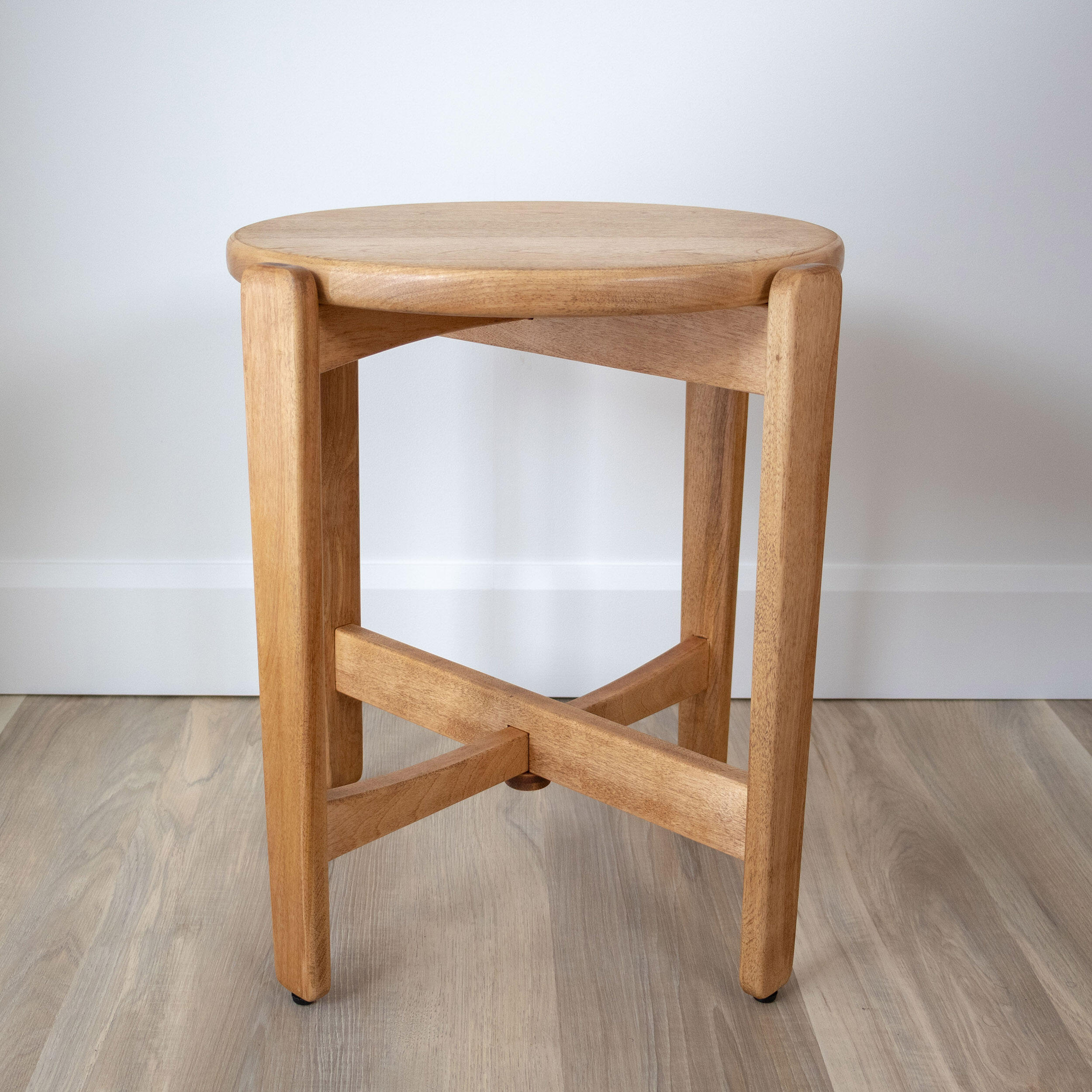 birch wood table with round top and 4 legs on white background