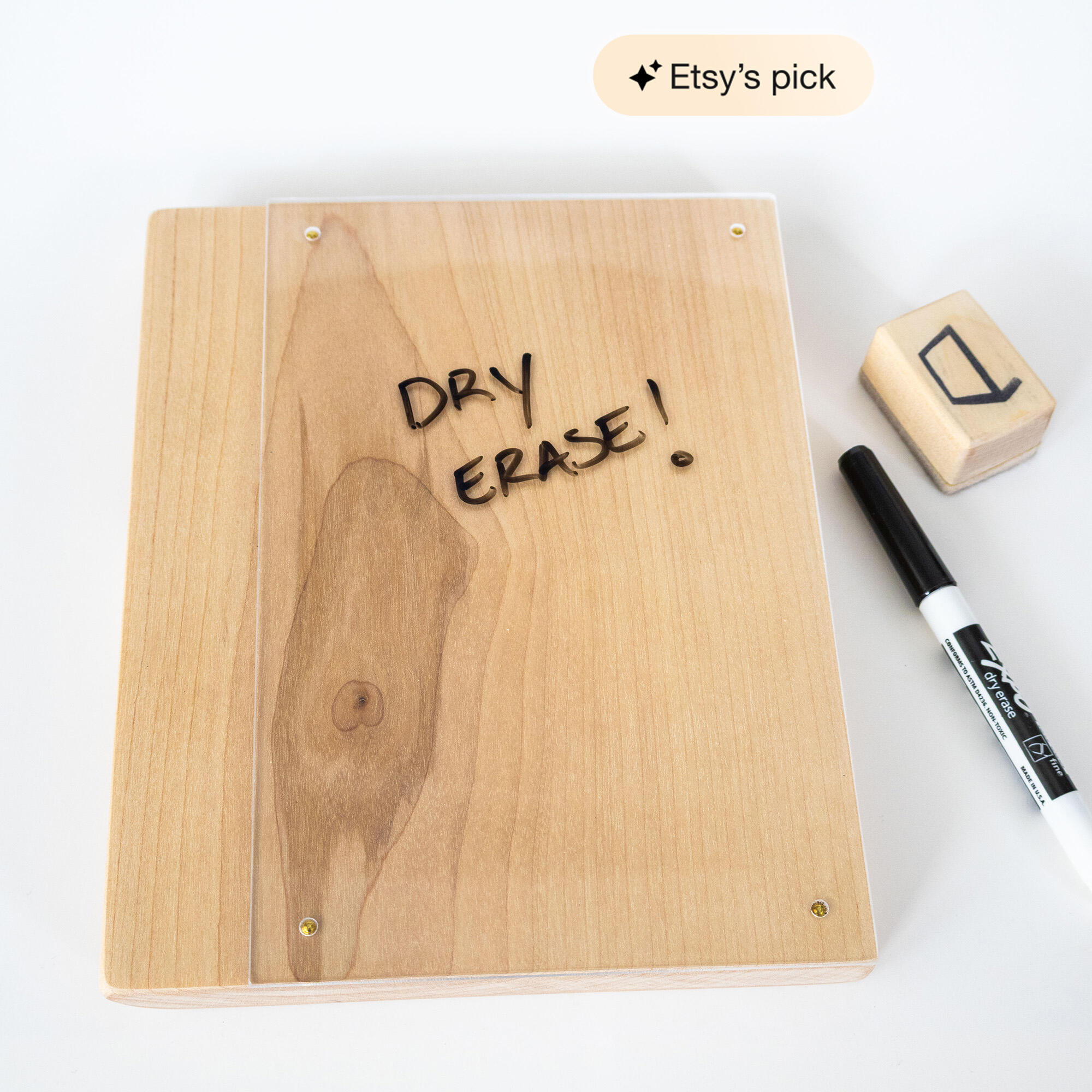 Minimalist wooden dry‑erase board with clear acrylic surface and brass corner nails, shown with a black marker and wooden eraser.