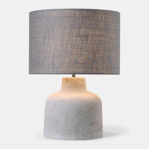 concrete base table lamp with dark grey fabric shade.