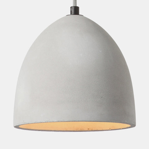 contemporary industrial concrete pendant lamp with grey fabric cord and chrome ceiling canopy. detail of concrete shade