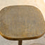 Multipurpose space saving cast aluminum side table in textured brass finish top detail.