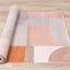  Belle Plush Rug - Pink / Grey Geometric Pattern roll on floor