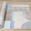 Belle Plush Rug - Blue / Grey Geometric Pattern roll on floor