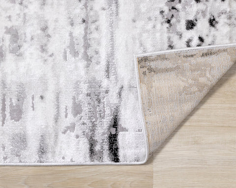 Chorus Distressed Rug - Black & White corner flipped to show underside