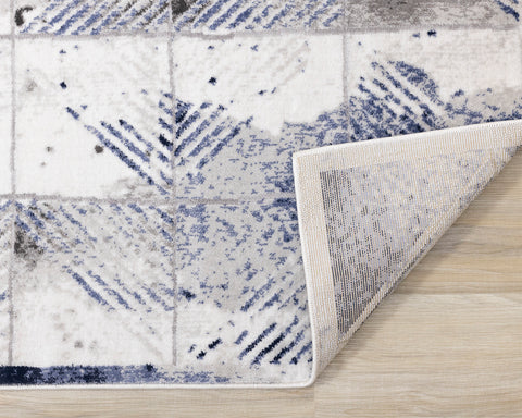 Chorus Distressed Rug - Blue & Grey Triangles corner flipped to show underside