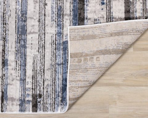 Darcy Rug - Grey / Blue Stripes corner flipped to show underside of rug