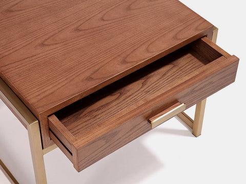 Bedside table with one drawer in MDF with walnut veneer & gold stainless steel frame. Drawer open for detail.