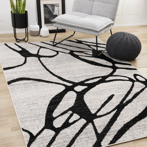 Eclipse Rug - Black Swirls in living room setting