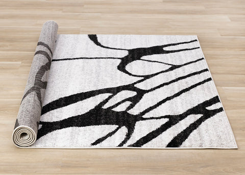 Eclipse Rug - Black Swirls roll on floor