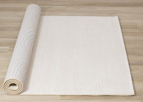 Ella Plush Rug - Cream Swirl roll on floor