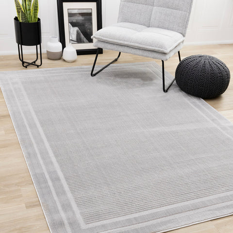 Ellington Rug - Grey Border in living room setting