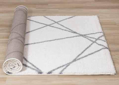 Fergus Shag Rug - Cream Grey Geometric Lines roll on floor