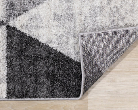 Focus Rug - Grey Faded Triangles corner flipped to show underside