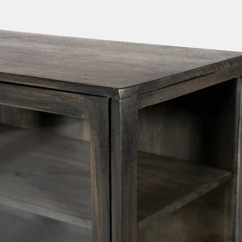 Solid mango wood sideboard in grey finish with 4 glass doors. Detail of corner.