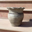  Grey terracotta vase with wide opening.