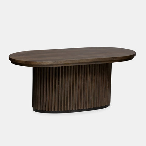 Solid mango wood oblong coffee table with repeating pattern ribbing base in dark olive finish.