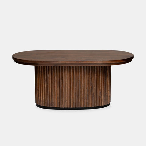 Solid mango wood oblong coffee table with repeating pattern ribbing base in brown finish.