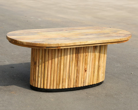 Solid mango wood oblong coffee table with repeating pattern ribbing base in natural finish.