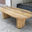 Solid mango wood oblong dining table with 2 repeating pattern ribbed legs in natural finish.