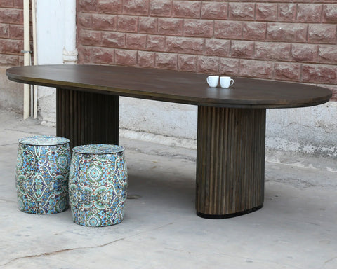 Solid mango wood oblong dining table with 2 repeating pattern ribbed legs in dark olive finish.