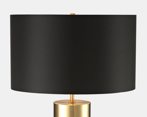 Table lamp with concrete and gold base and black fabric shade. view of shade