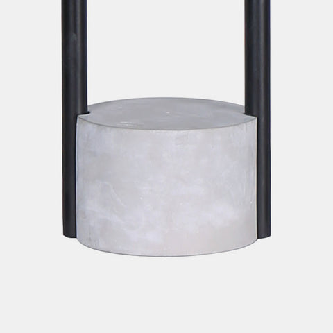 modern industrial concrete and black accent table lamp featuring a white linen shade. detail of concrete base