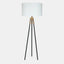 Industrial modern tripod floor lamp. White linen shade, black legs and gold accents.