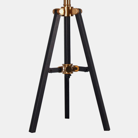 Tripod table tamp with black base and white linen shade view of base