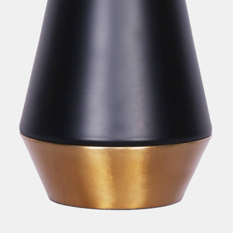 geometric modern table lamp with black and gold metal base featuring a white linen drum shade. detail of base