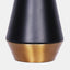 Table lamp with matte black and gold metal base, and white linen drum shade. Detail of base.