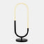 minimal LED table lamp. Oval tube half black metal, half LED diffuser sitting on a circular base.