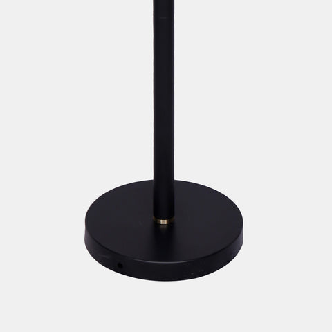 mid-century modern floor lamp with matte black metal base and 3 extended arms featuring metal orb shades in brushed gold. detail of base.