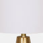 Shade view of mid-century modern table lamp with white linen shade and black matte base with gold accent.