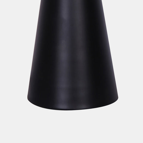 Base of mid-century modern table lamp with white linen shade and black matte base with gold accent.