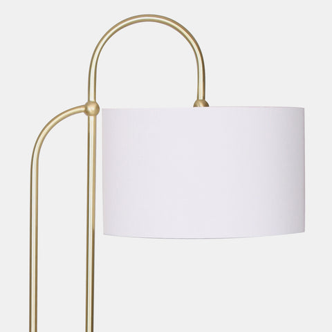 Arched floor lamp in traditional contemporary and mid century style in brushed gold with an off white linen shade. Detail of body and shade.