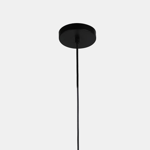 Matte black metal pendant lamp with a black cord and black canopy. close-up of shade. detail of canopy