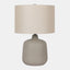 Ceramic Table Lamp with beige drum shade, and warm grey vase-shaped base.