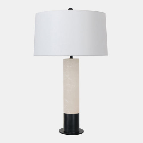 Table lamp with alabaster column body sitting on Matte black metal base & tapered white linen shade.