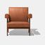 Caramel brown leather lounge chair with leather armrests and solid ash wood legs stained walnut.