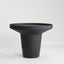 Minimal black powder coated aluminum side table resembling a pier bollard with a black marble base.