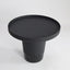 Minimal black powder coated aluminum side table resembling a pier bollard with a black marble base.