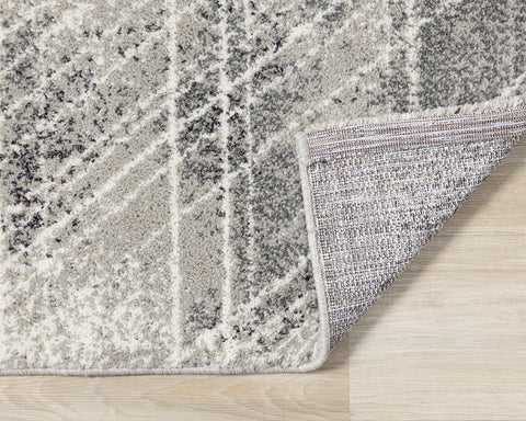 Ravine Rug - Grey Cream Distressed Lines corner flipped to show underside