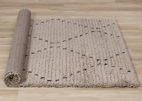 Rondo Rug - Black Diamond Stitch roll on floor