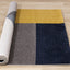 Safi Rug - Geometric Blue Grey Yellow roll on floor