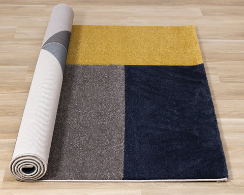 Safi Rug - Geometric Blue Grey Yellow roll on floor