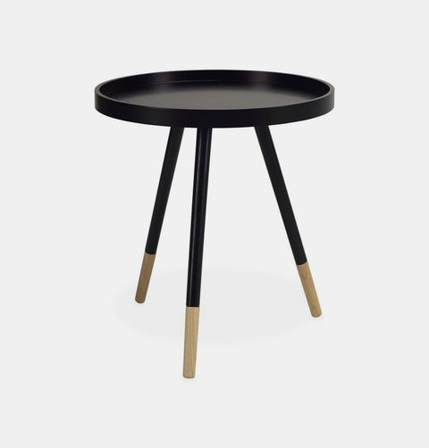 Black round side table with 3 white painted oak legs including exposed natural finish at base. 