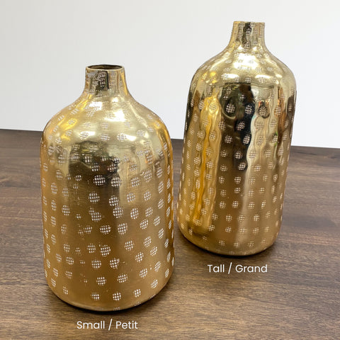 2 hammered aluminum bottle shaped vases in brash finish with engraved patterns and a small mouth opening.