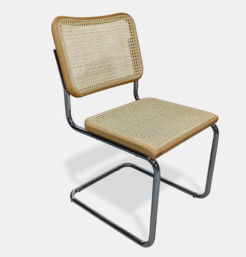 Modern side chair with a natural rattan seat and back framed in clear beech wood, sitting on tubular chrome plated cantilevered steel legs.