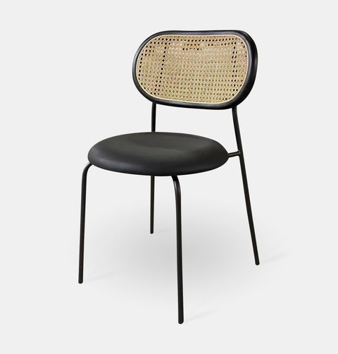 Black Bohemian chic Scandinavian style dining chair with black synthetic leather seat, natural rattan back framed in black stained ash wood.