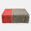 Handmade wool braided square floor pouf in natural grey with offset coral braiding.